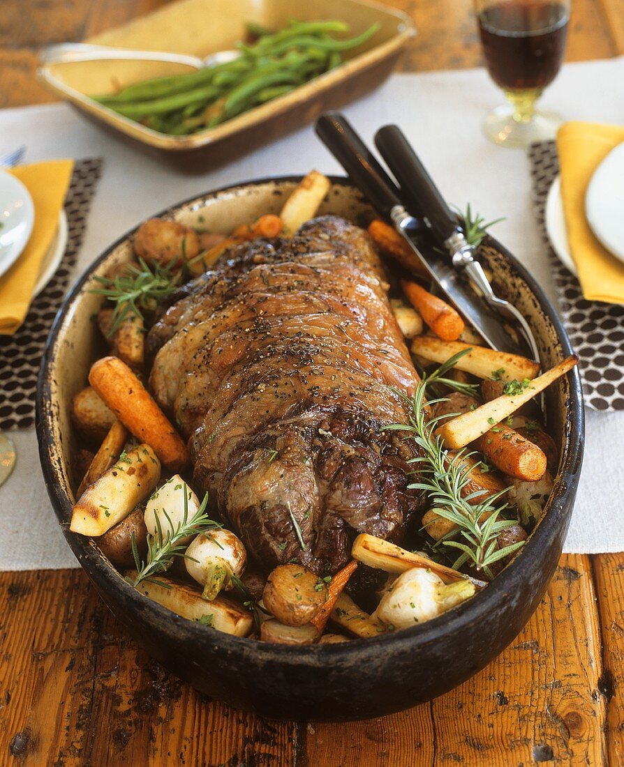 Rolled lamb roast with root vegetables and rosemary