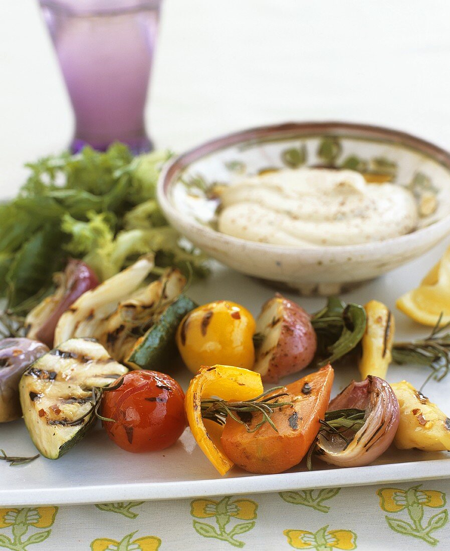 Grilled vegetables on rosemary skewers with hummus