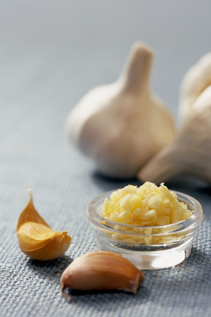 Garlic Cloves, Small Bowl of Chopped Garlic and Garlic Bulbs