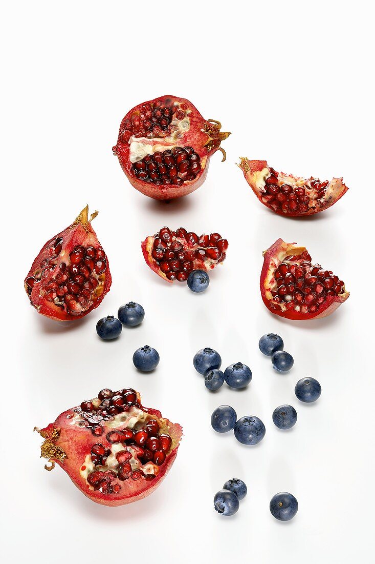 Pomegranate Pieces and Blueberries on a White Background