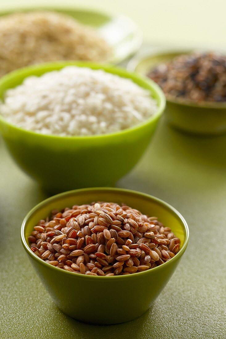 Bowls of Assorted Dried Rice, Bowl of Red Rice and Bowl of White Rice