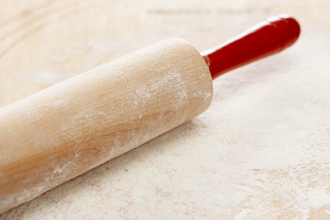 A Floured Rolling Pin with Red Handles