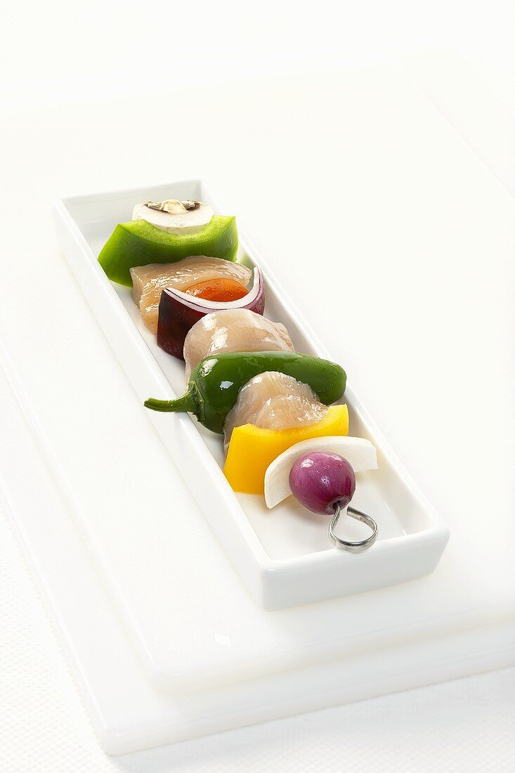 Uncooked Chicken and Vegetable Kabob on a White Rectangular Dish