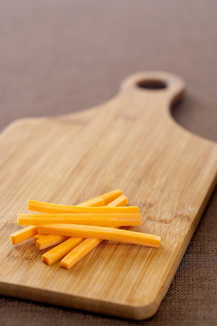 Carrot Sticks on a Cutting Board