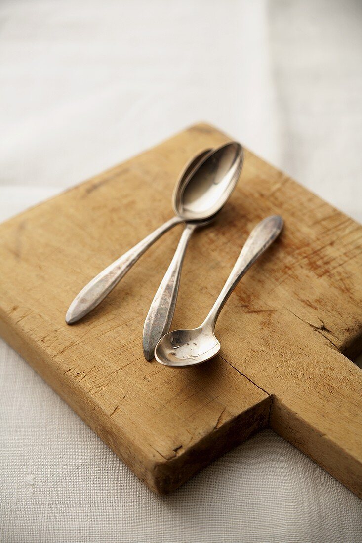 Three Spoons on a Cutting Board