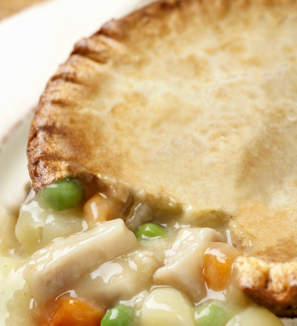 Close Up of Chicken Pot Pie with Part of Crust Removed to Show Filling