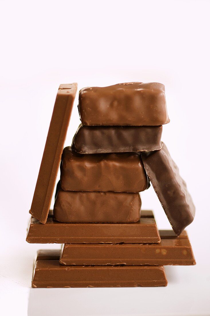 Assorted Bite-Sized Chocolate Candy Bars Stacked on a White Background