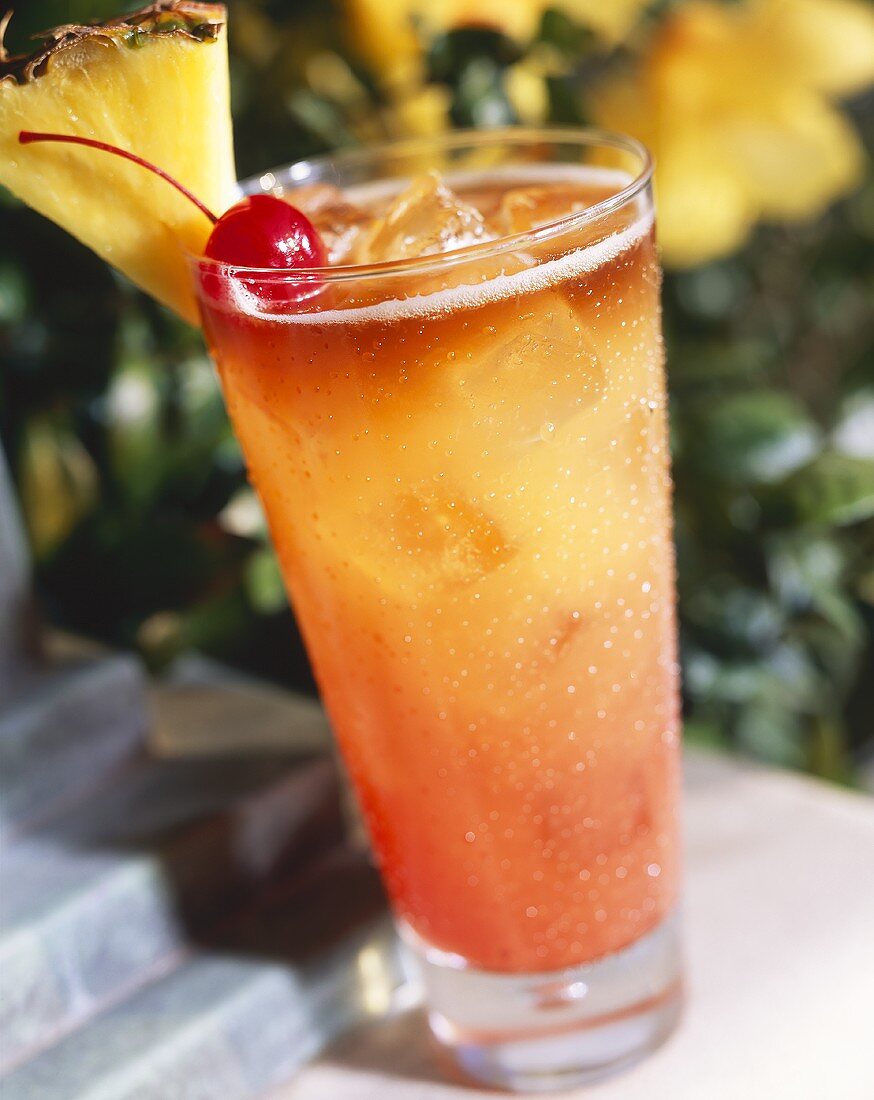 Tropical Drink (Mai Tai) with Pineapple and Cherry Garnish