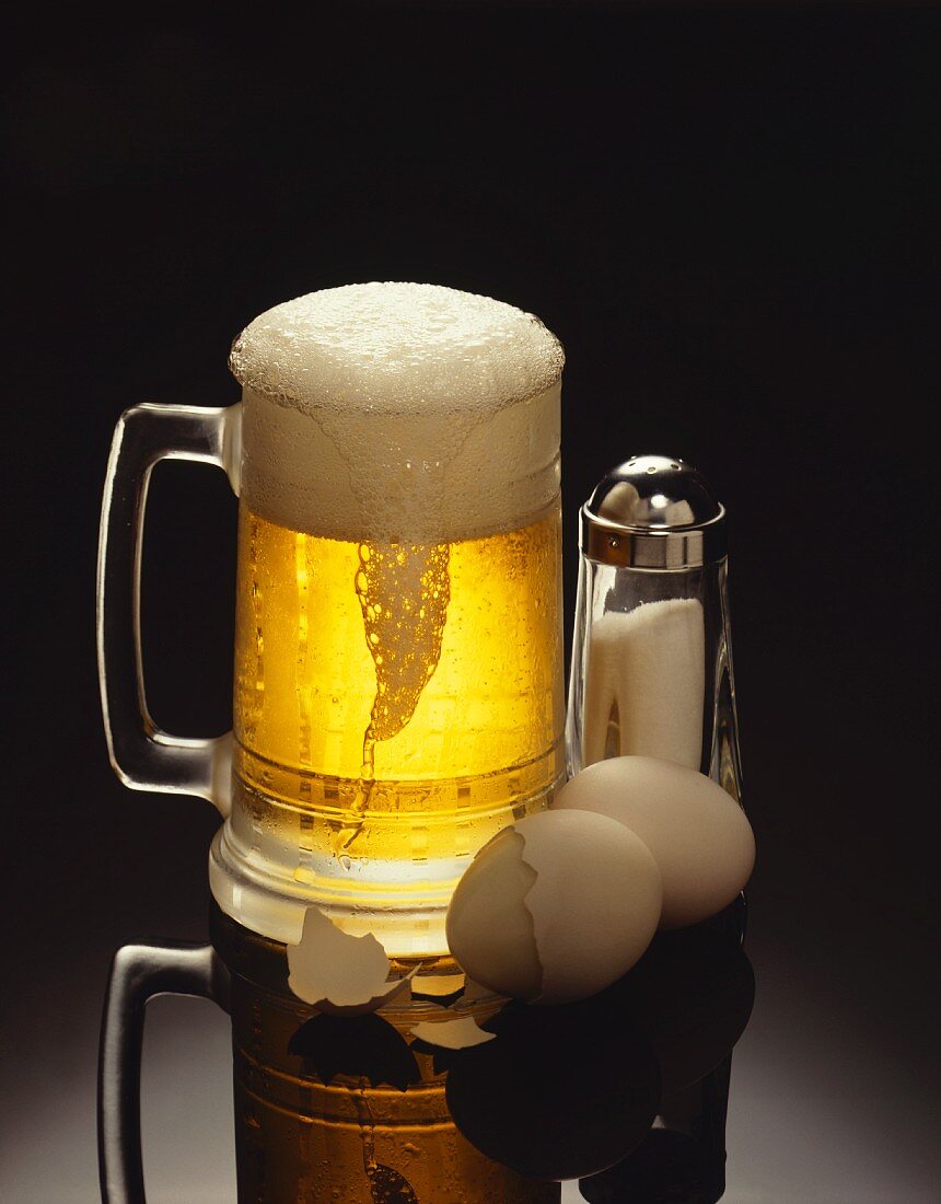 A Mug of Beer with Hard Boiled Eggs and a Salt Shaker