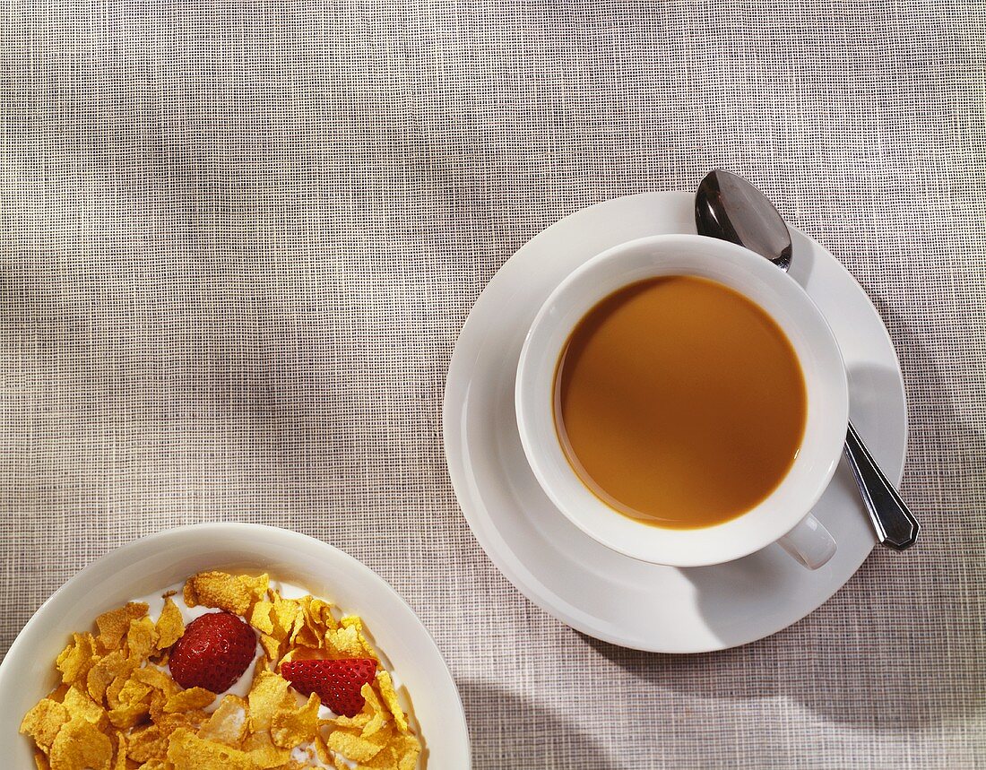 Cup of Coffee with a Bowl of Cornflakes and Strawberries