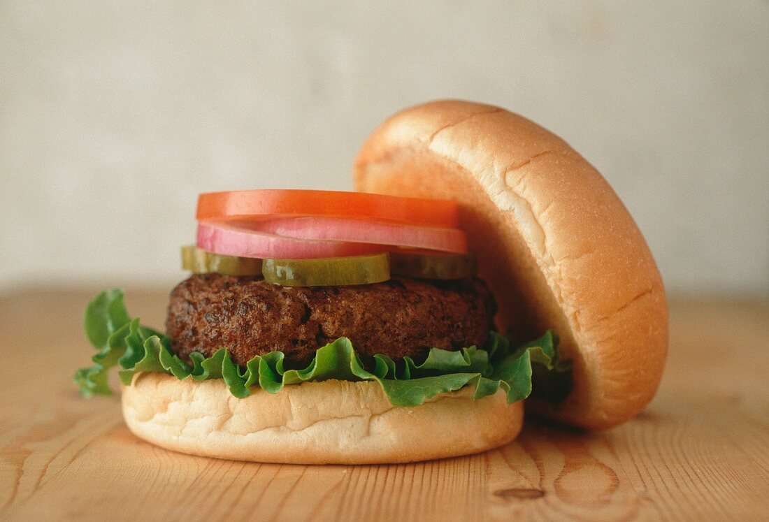 Hamburger with Onion, Tomato, Pickles and Lettuce; On a Bun
