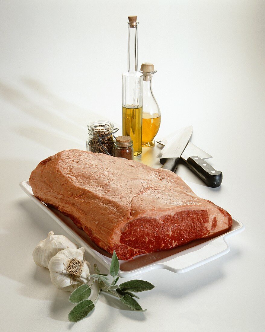 Rib Eye Roast on Tray with Oils and Knifes