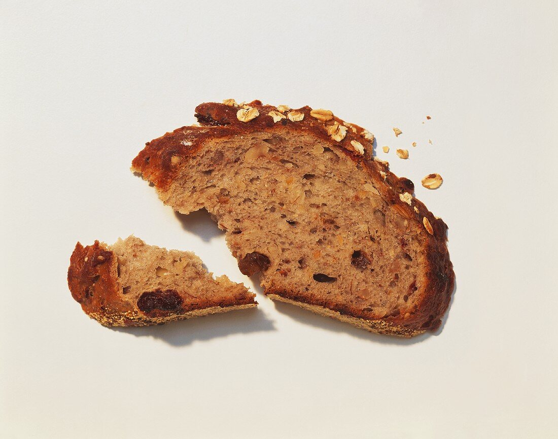 A Slice of Whole Grain Bread with a Piece Broken off