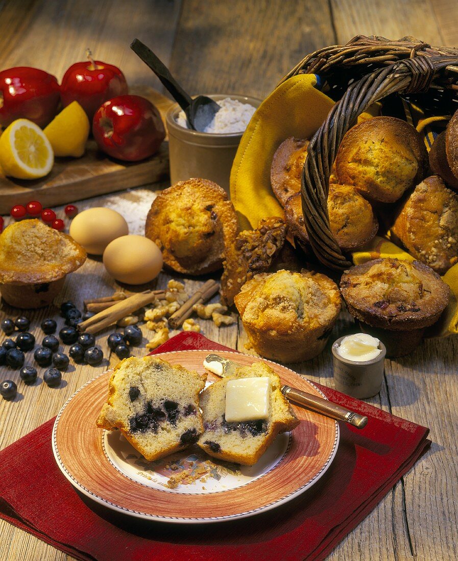 Blueberry muffin with butter; ingredients; basket of muffins