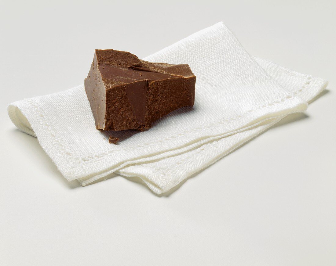 Piece of Chocolate Resting on a Linen Napkin