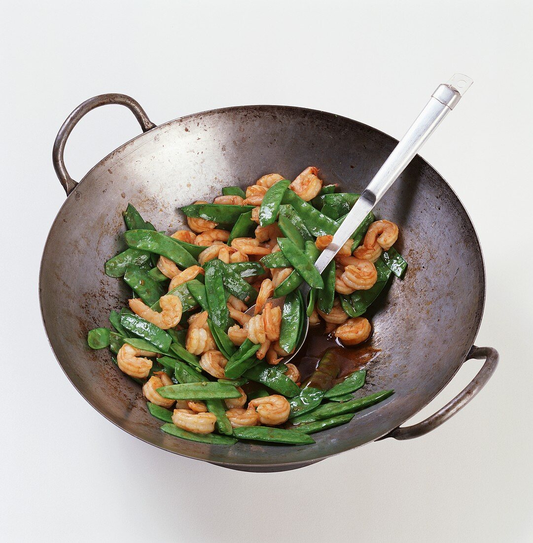Shrimp and Pea Pods Stir Fried in a Wok