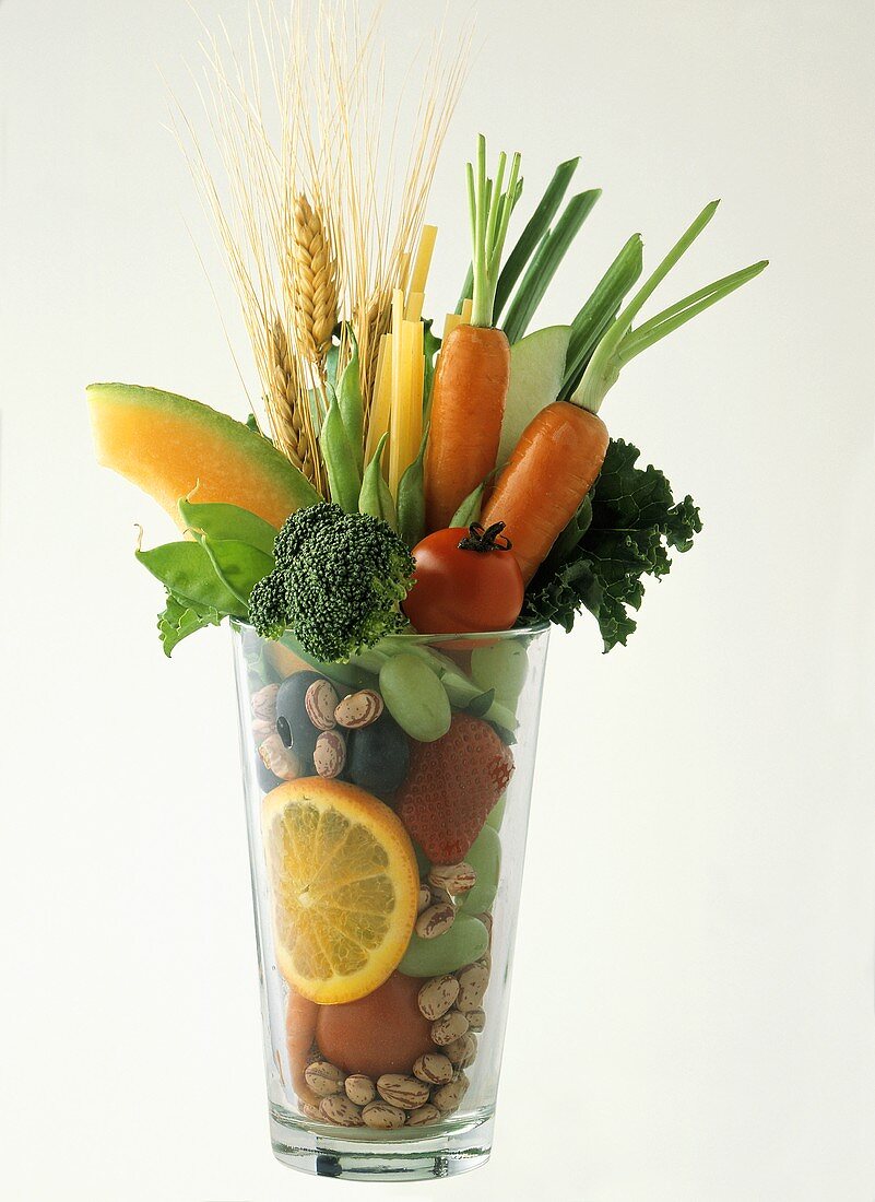 Früchte, Gemüse, Nudeln und Getreideähren in einem Glas