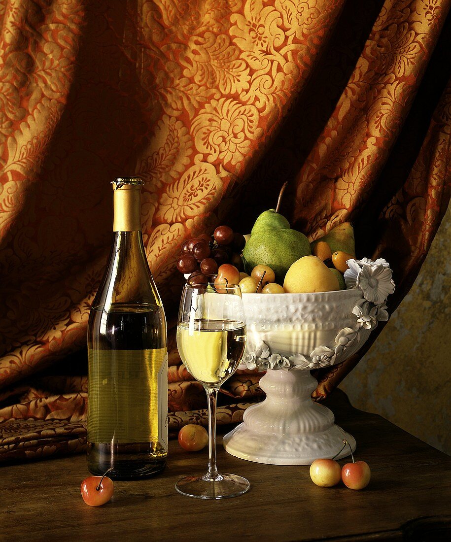Still life with white wine and fruit bowl