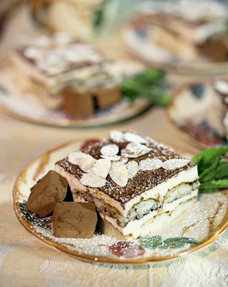 Tiramisu with flaked almonds on plate