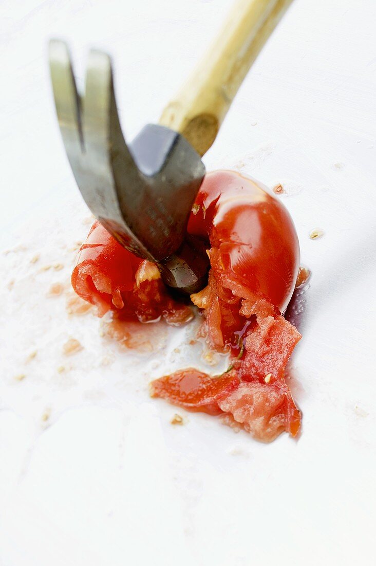 Hammer squashing a tomato