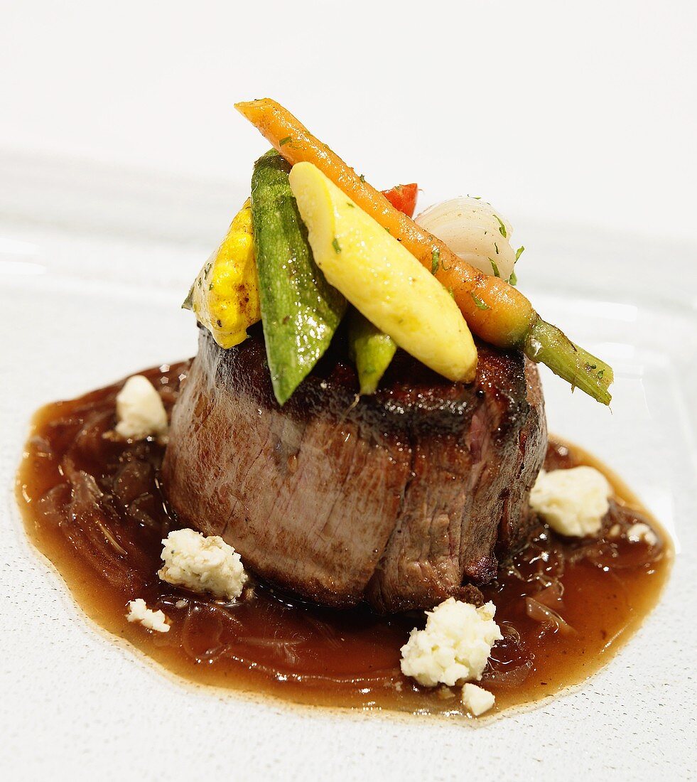 Fillet Mignon Topped with Baby Roasted Vegetables and Blue Cheese in a Balsamic Glaze