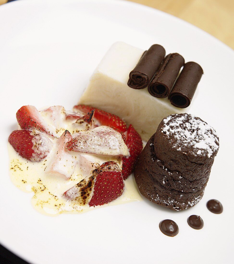 Two chocolate desserts and one strawberry dessert on plate
