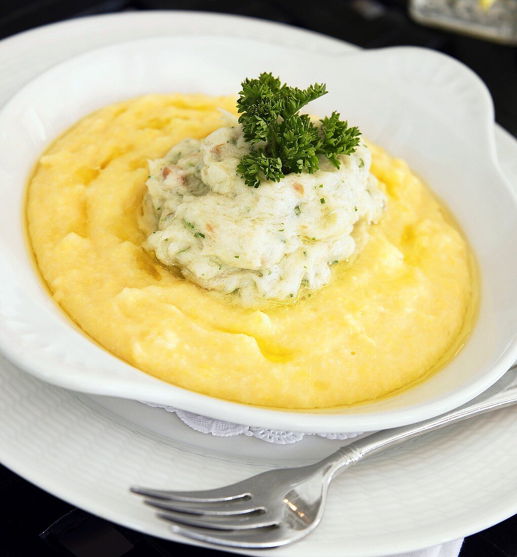 Bowl of Polenta Topped with Cod and Curly Parsley, Fork