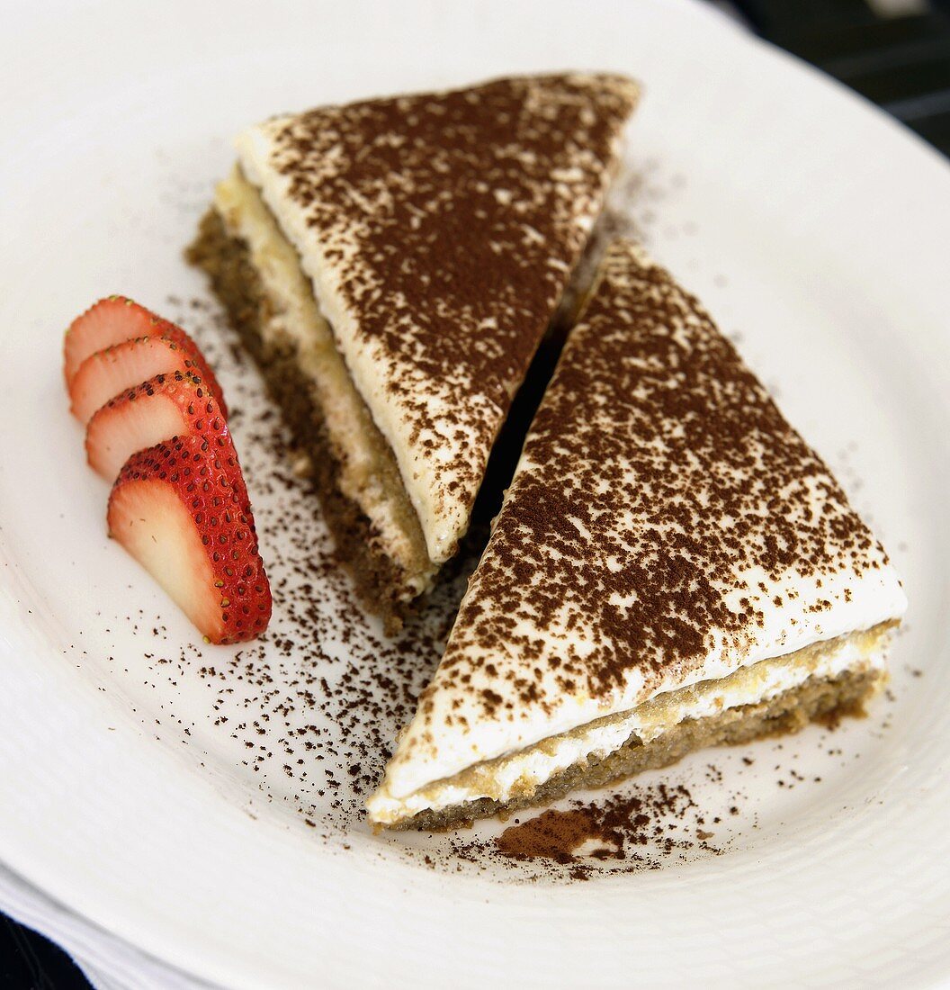 Two Pieces of Tiramisu on a Plate with Sliced Strawberry