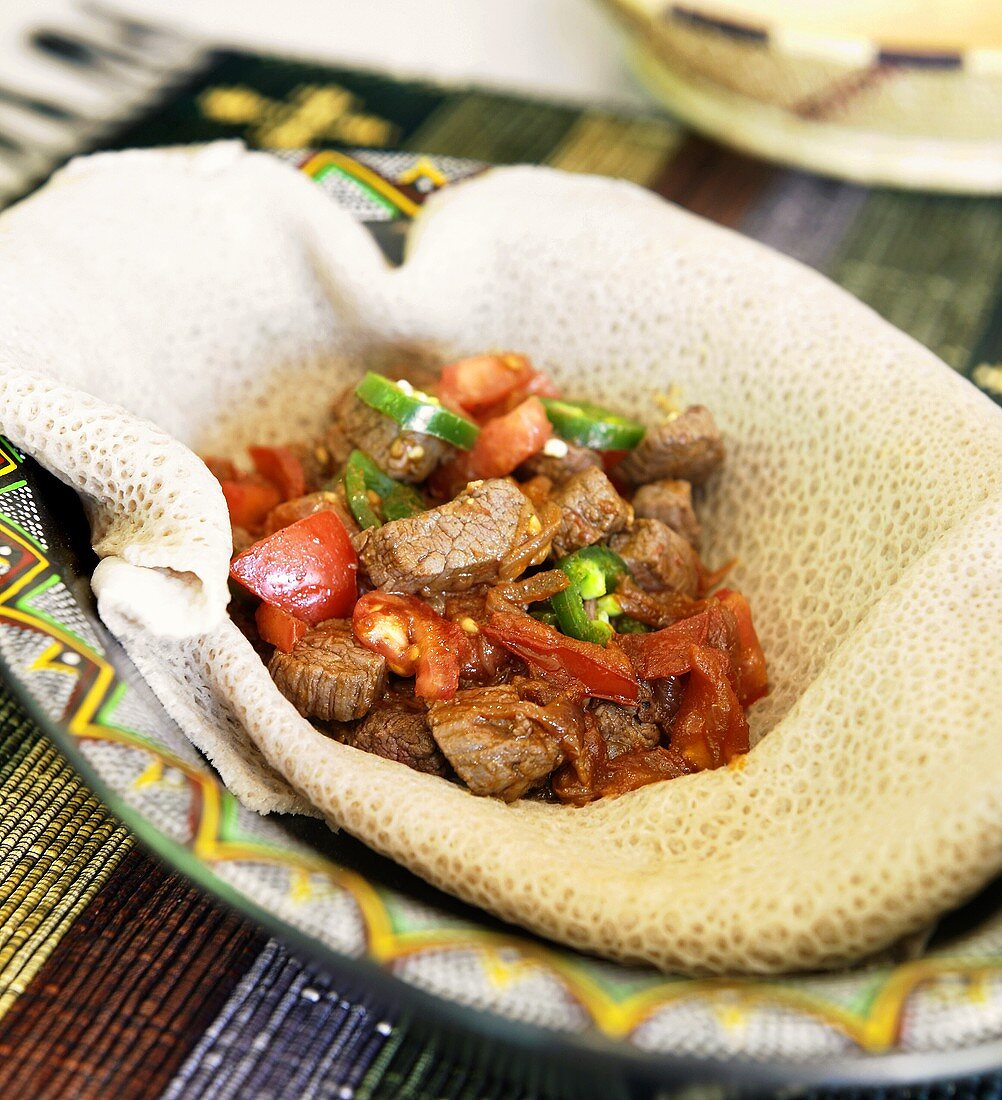Beef and Vegetables on Injera in a Bowl
