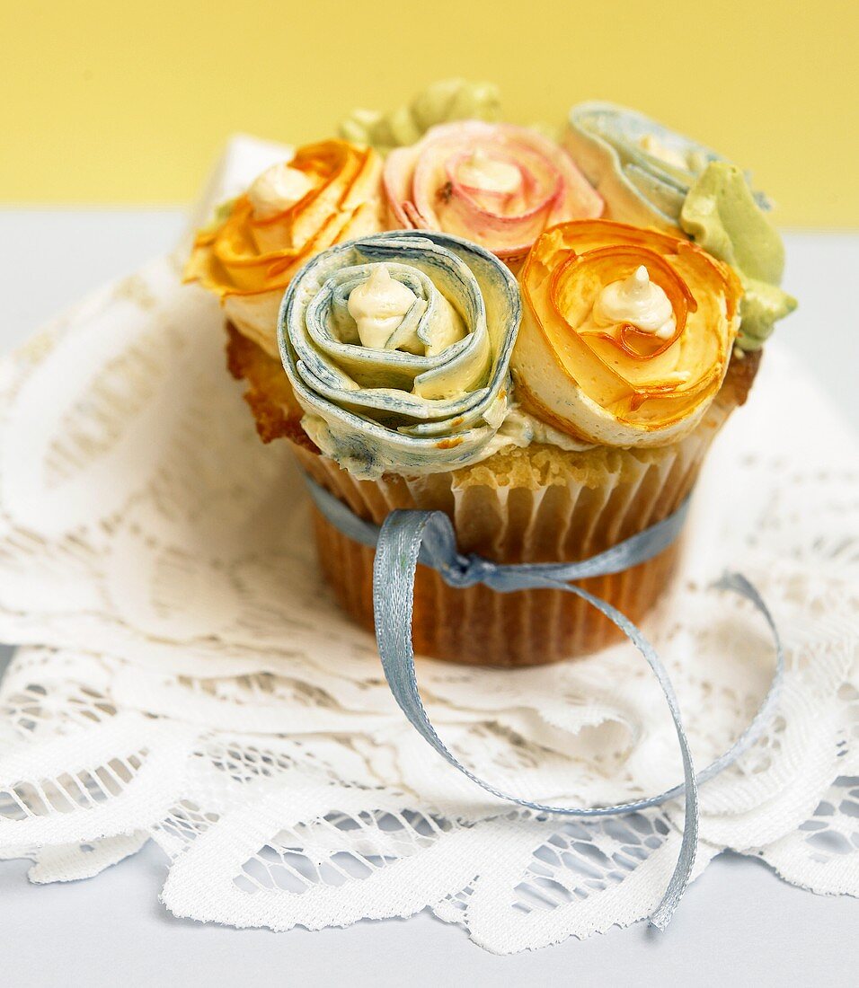 A Single Cupcake Decorated with Frosting Rose Buds