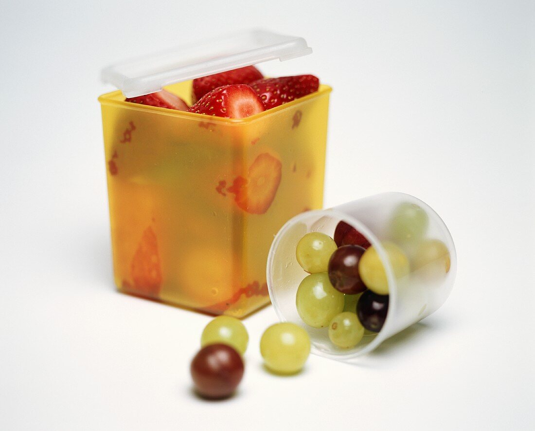 Strawberries and Grapes in Storage Containers