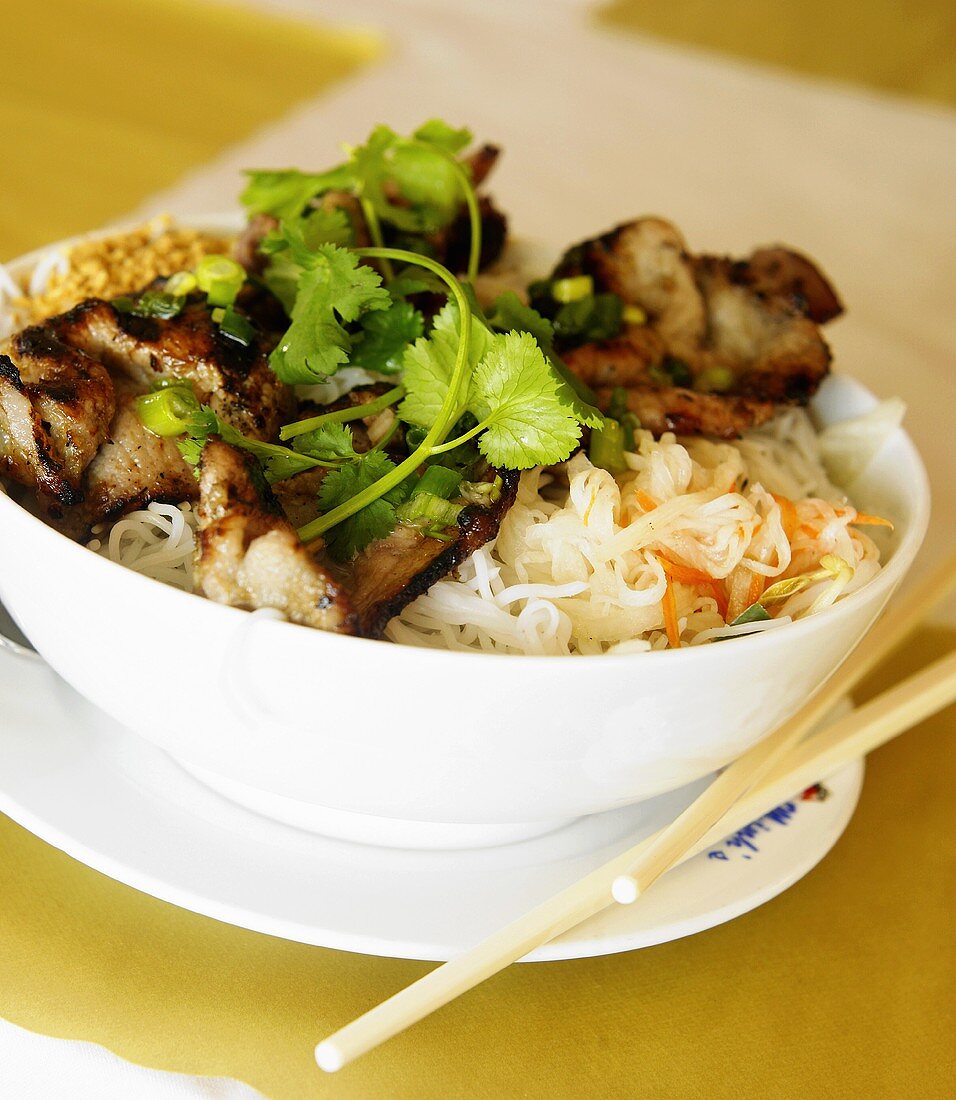 Bowl of Vietnamese Noodles Topped with Pork, Chopsticks