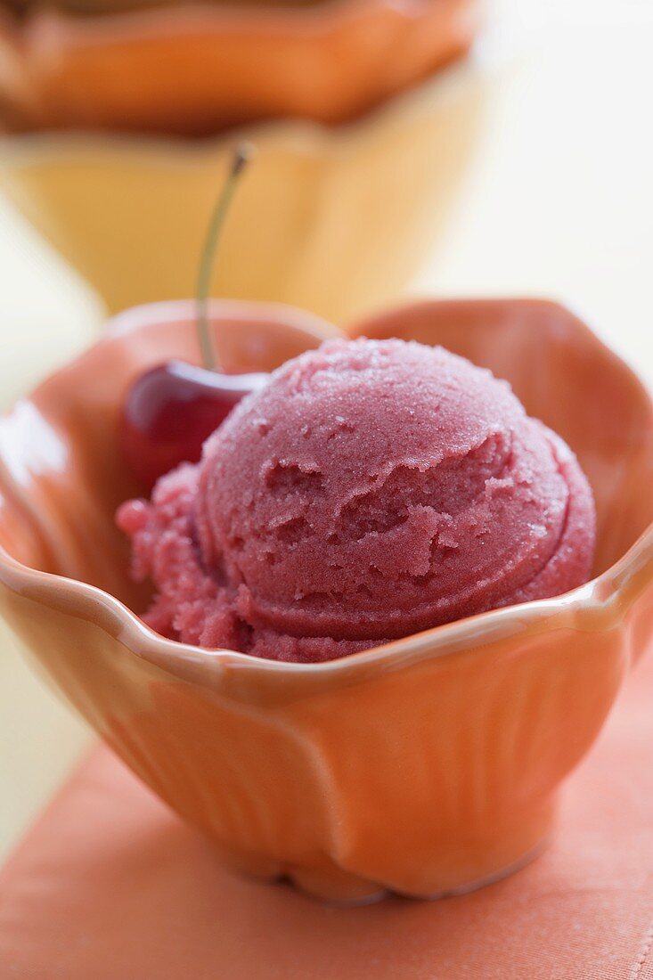 Raspberry Sorbet in a Bowl with a Cherry