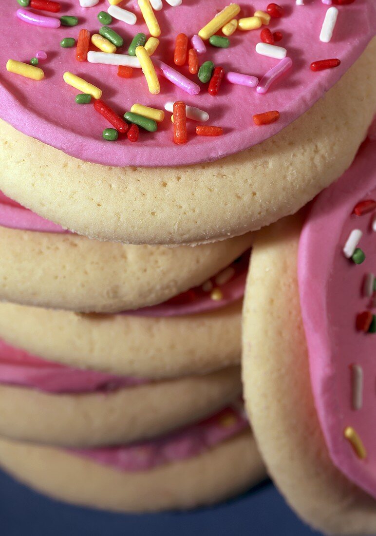 Stack of Pink Frosted Sugar Cookies with Colored Sprinkles