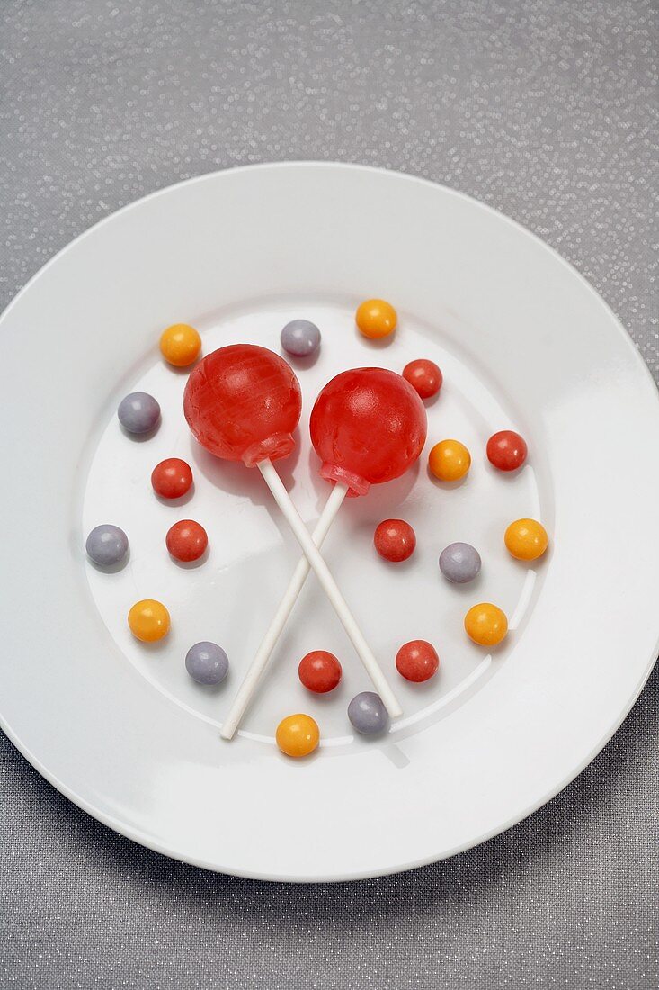 Two Lollipops with Candies on a White Plate