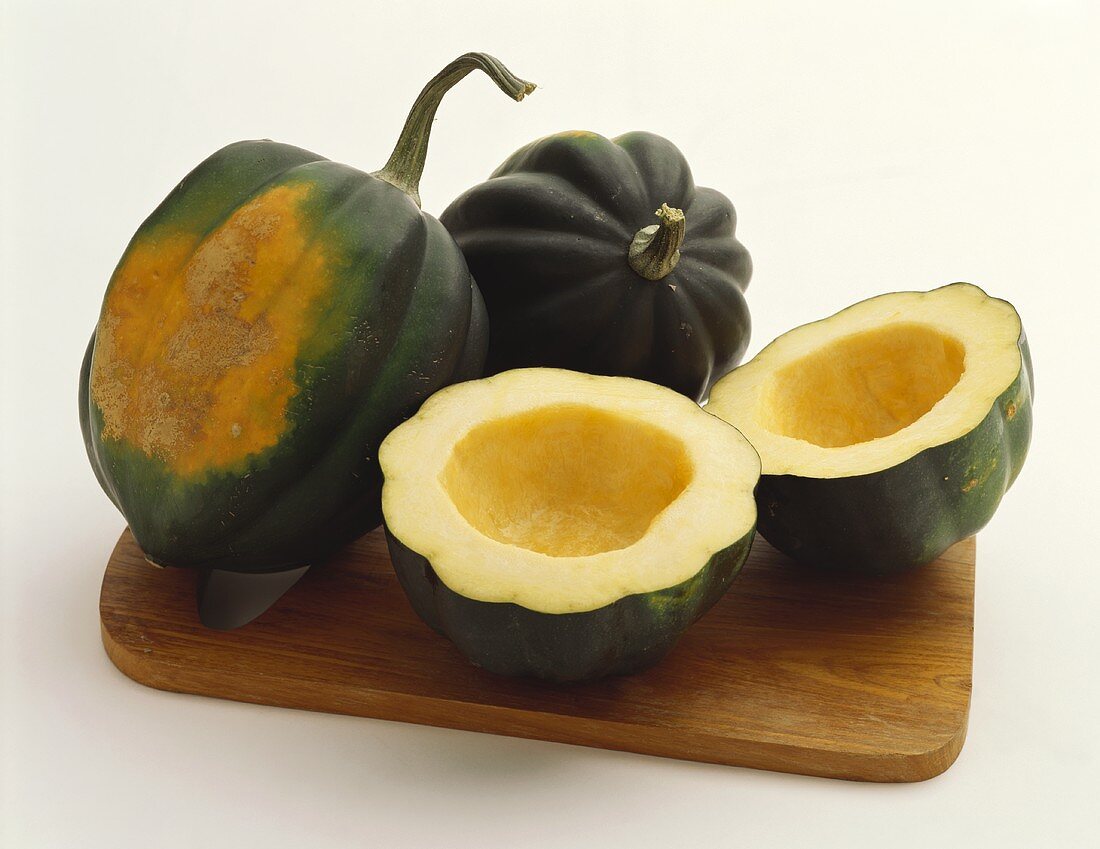 Acorn Squash on a Wooden Board: Whole and Halved