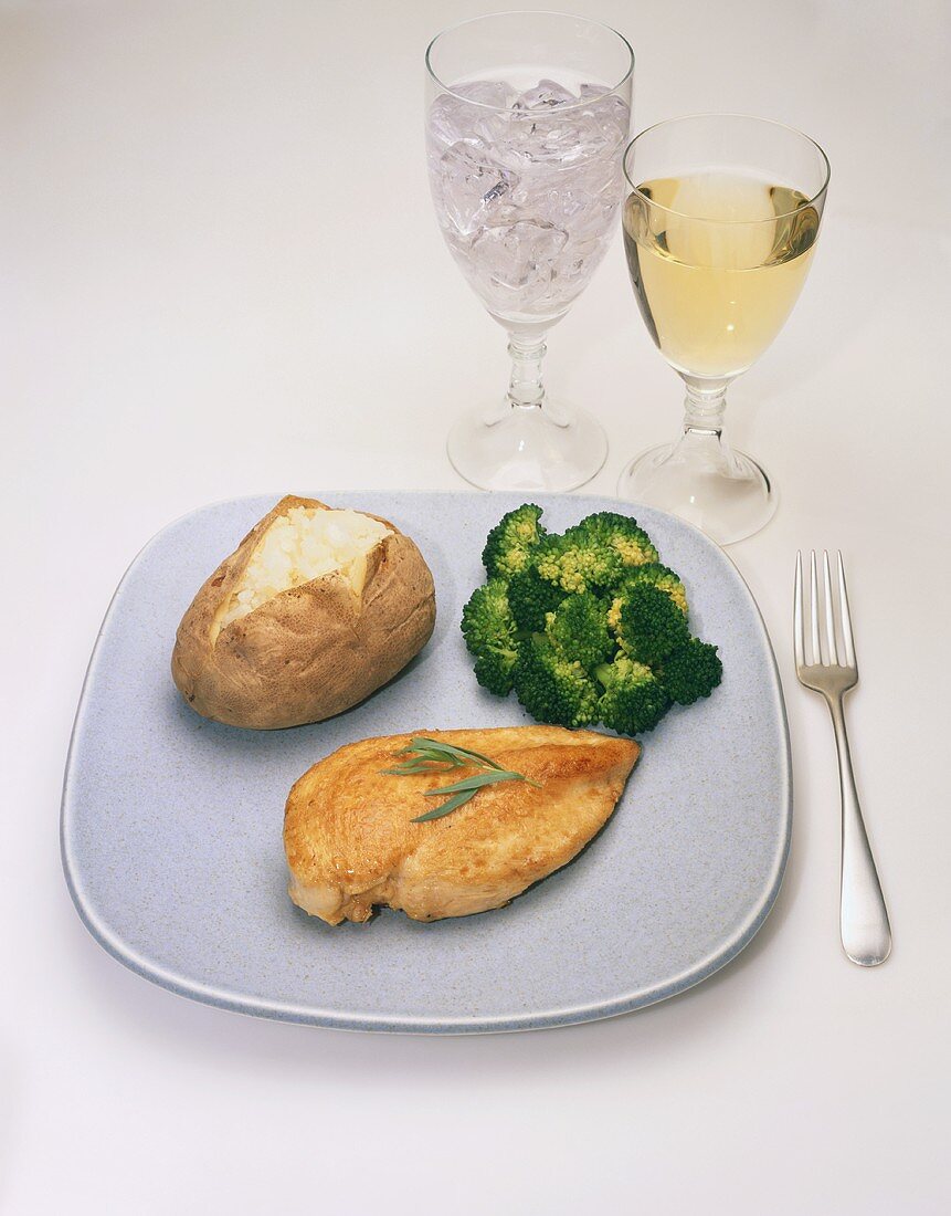 Dinner of Chicken Breast with Baked Potato and Broccoli; Water and White Wine