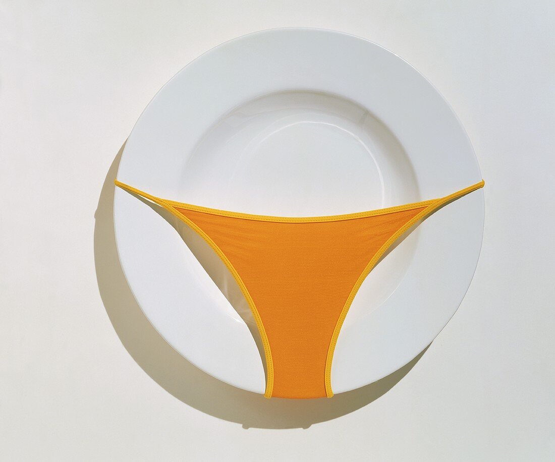 Empty White Plate with an Orange Bikini Bottom on It