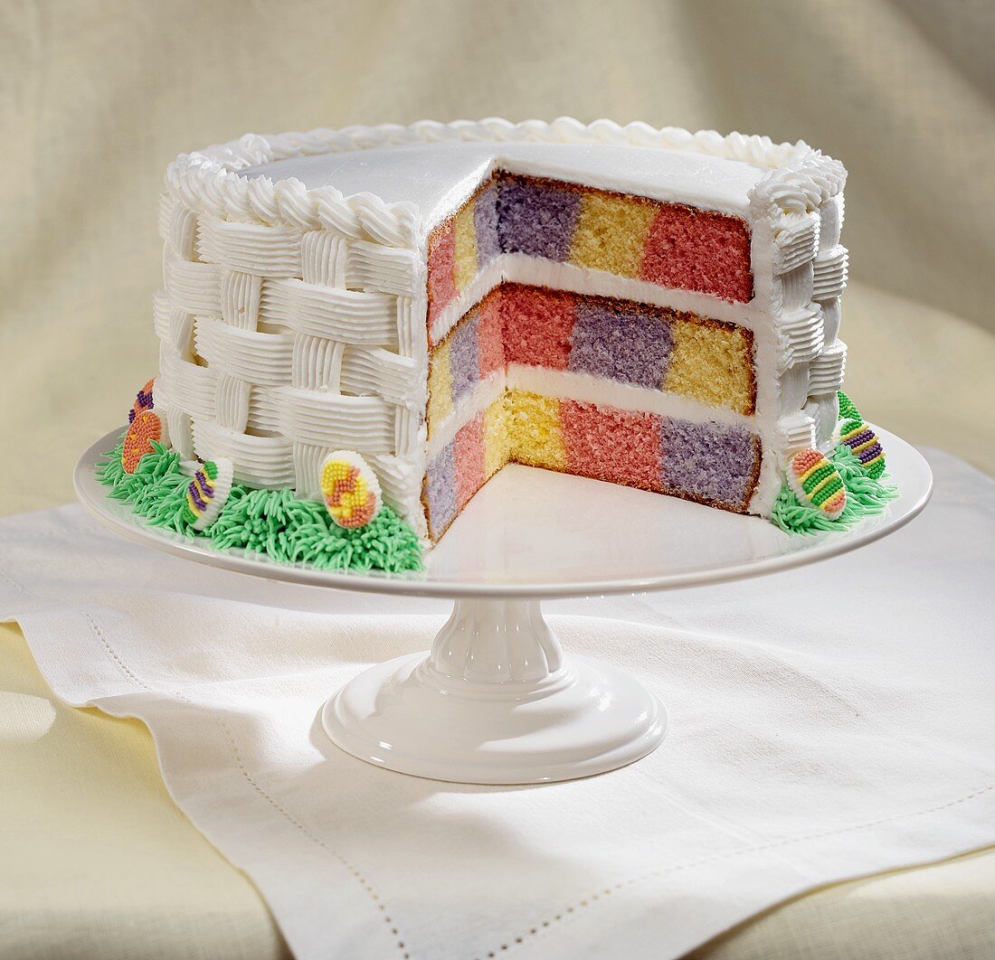 Colorful Checkered Easter Cake with White Frosting, Slice Removed