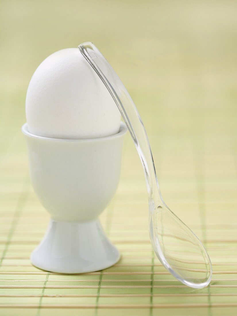 Soft Boiled White Egg in an Egg Cup with a Plastic Spoon