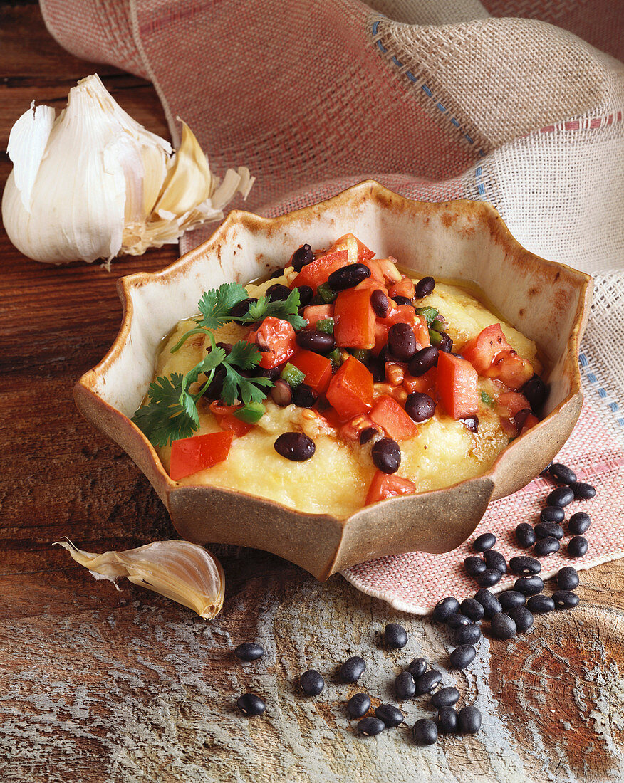 Bowl of Polenta Topped with Black Bean and Tomato Salsa; Black Beans and Garlic