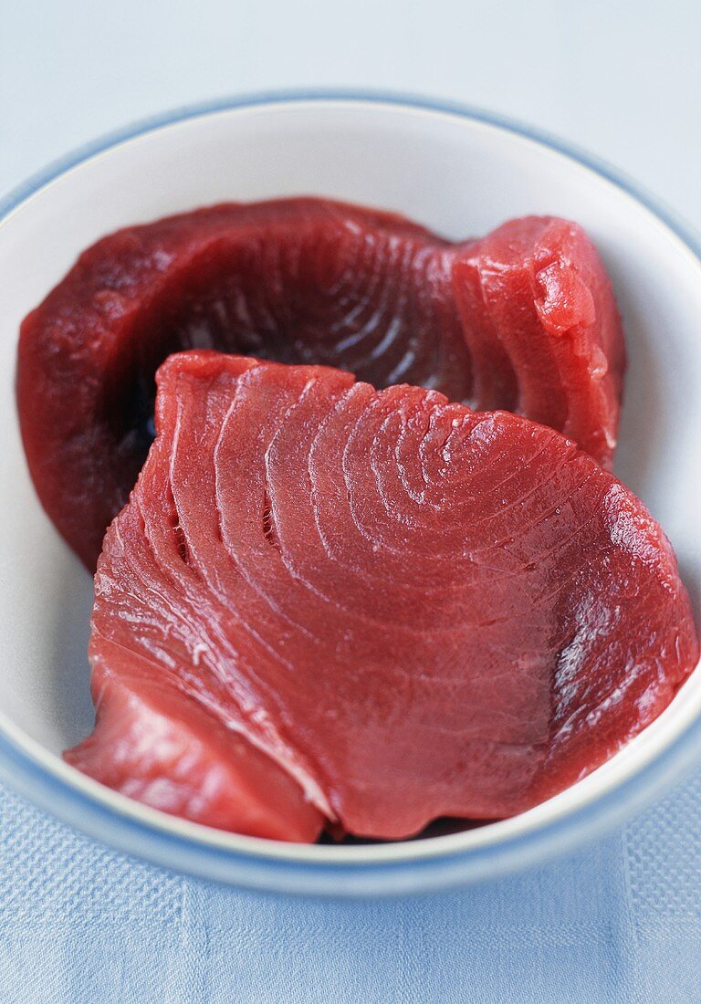 Two Fresh Tuna Steaks in a Bowl; Close Up