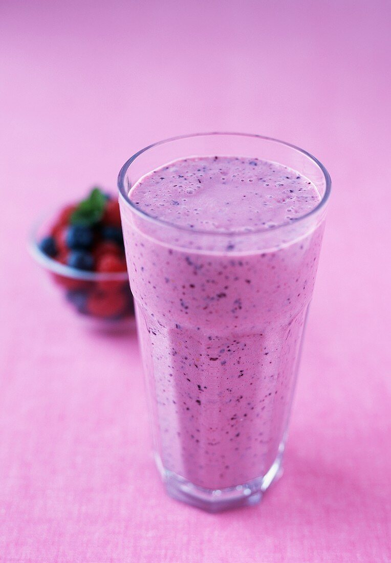 Berry Smoothie in a Glass; Purple Background