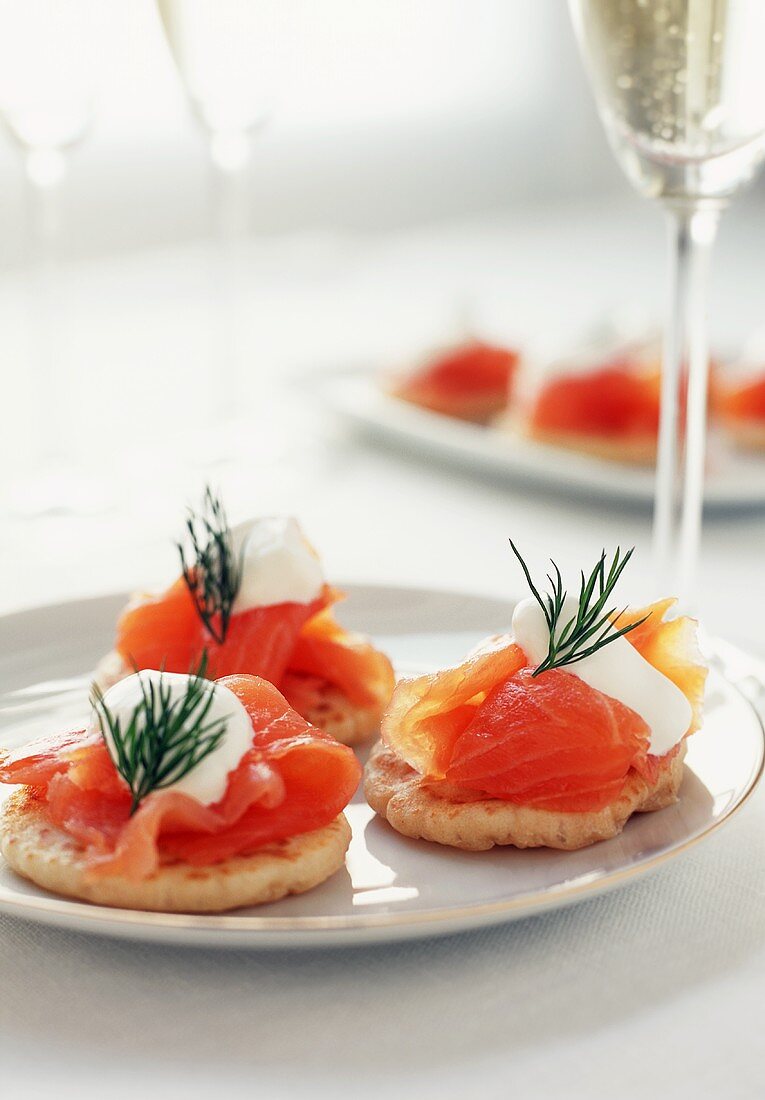 Smoked Salmon Blini on a Plate; Glasses of Champagne