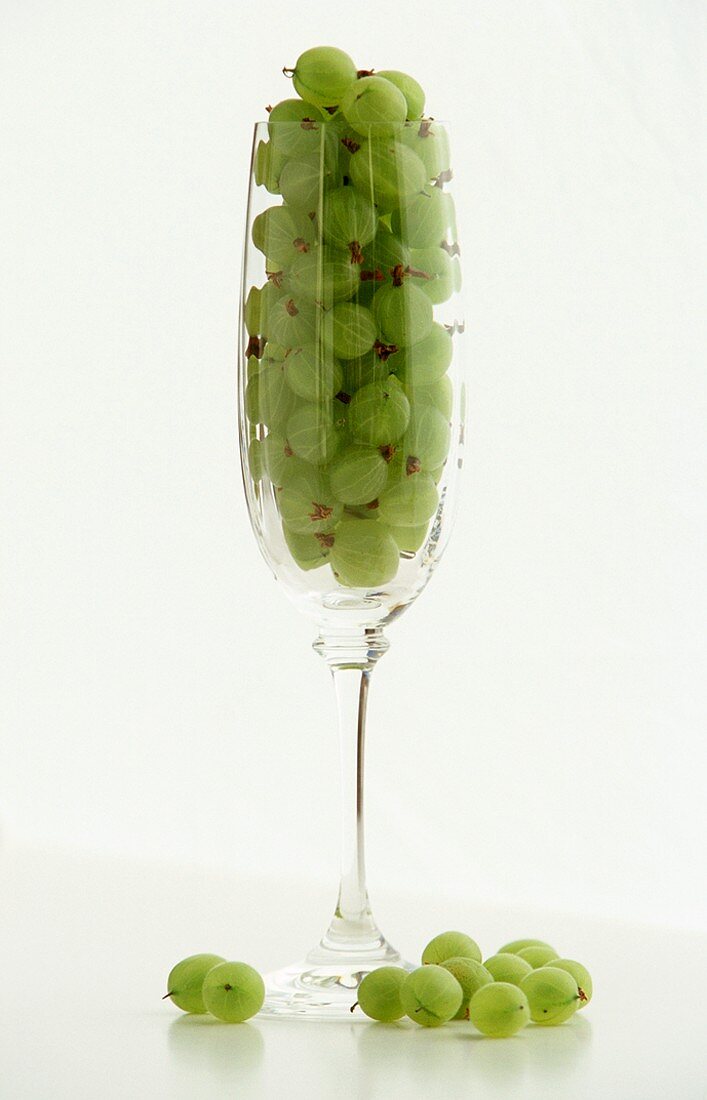 Gooseberries In and Beside a Champagne Flute, White Background