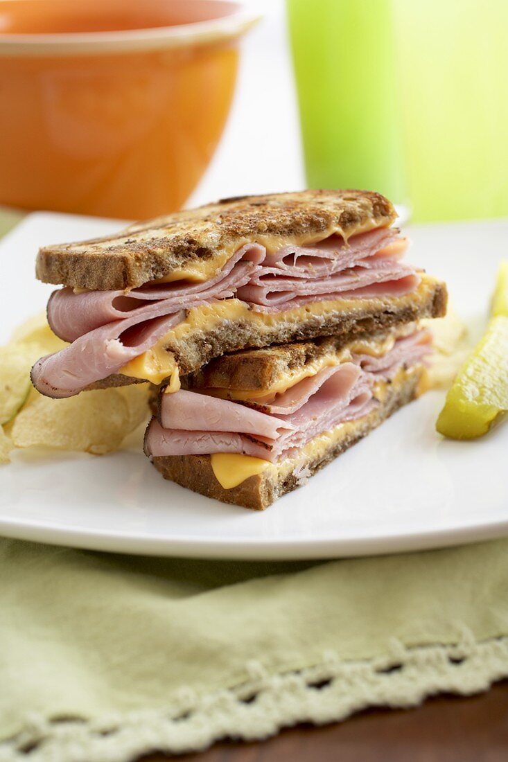 Halved Grilled Ham and Cheese Sandwich on a Plate