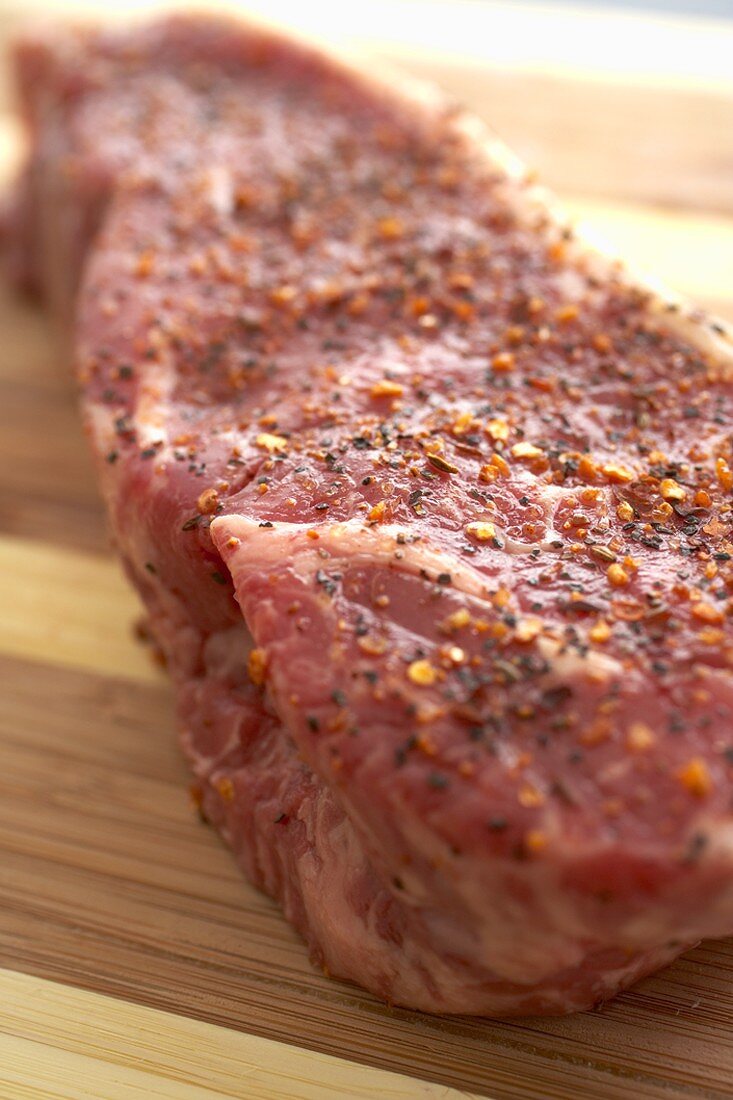 Seasoned Raw Top Sirloin Steak on a Cutting Board