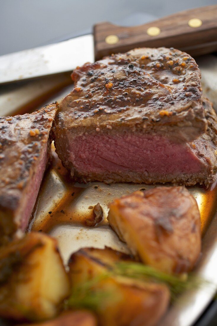 Top Sirloin Cooked Medium-Rare Sliced with Potatoes