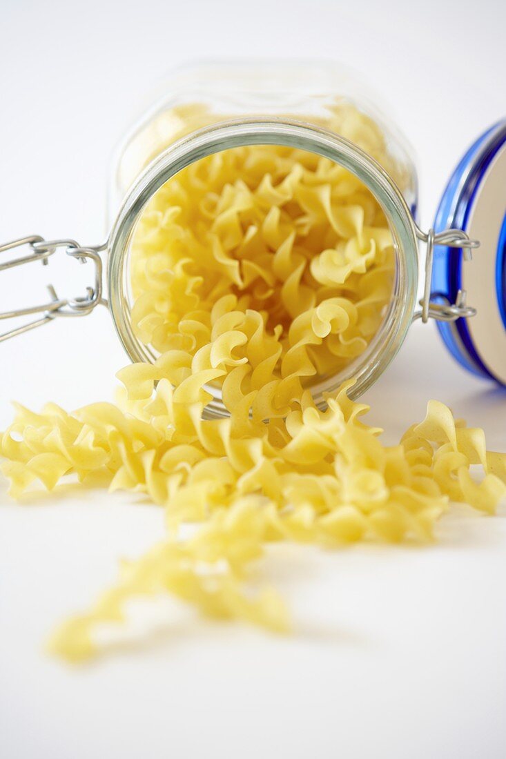 Organic Egg Noodles Spilling From a Canister
