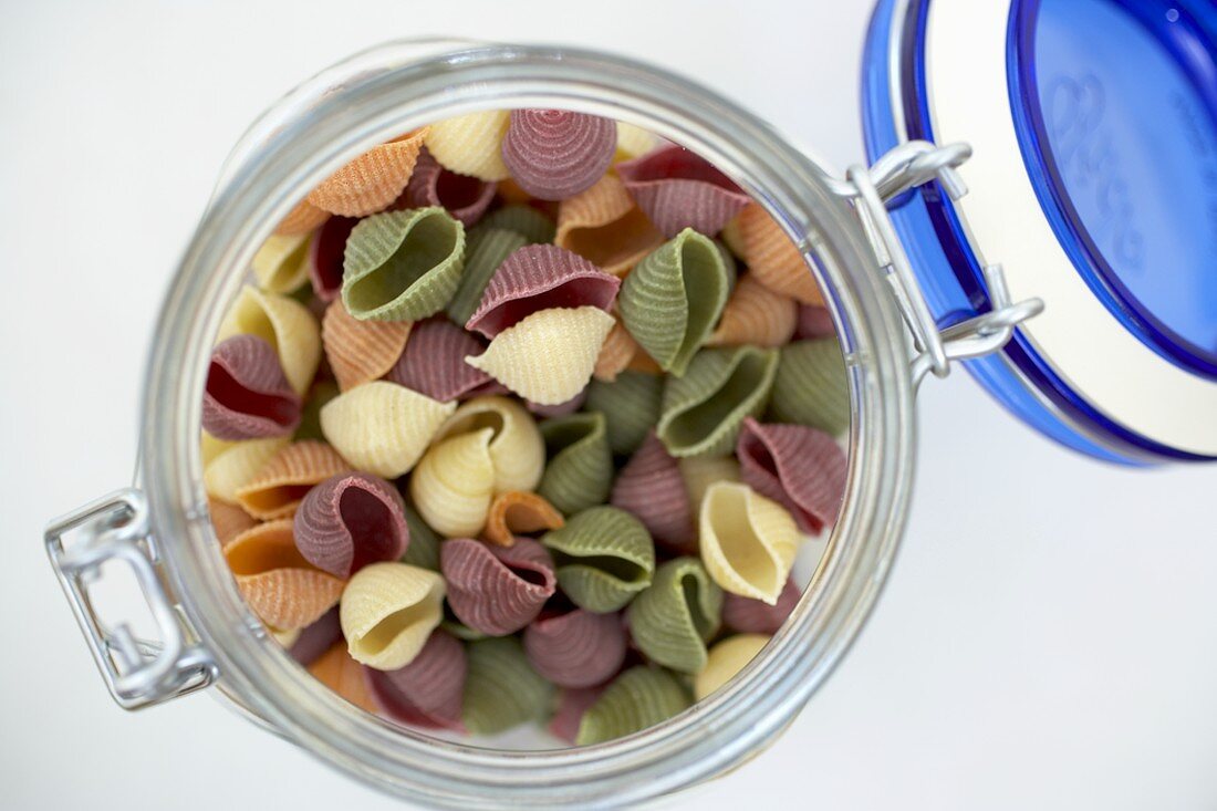 Organic Multi-Colored Shell Pasta in an Opened Canister